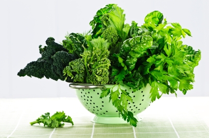 Dark green leafy fresh vegetables in metal colander