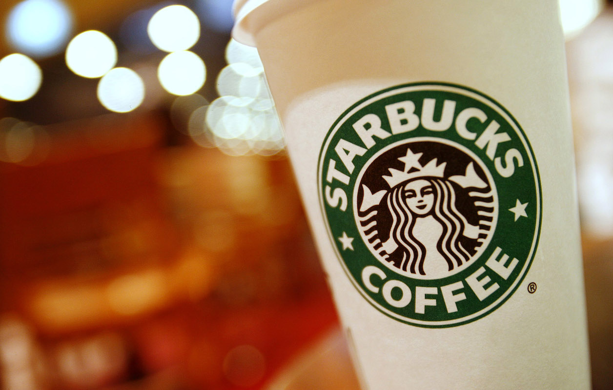 A cup of Starbucks coffee sits on a table in a cafe in central Hong Kong