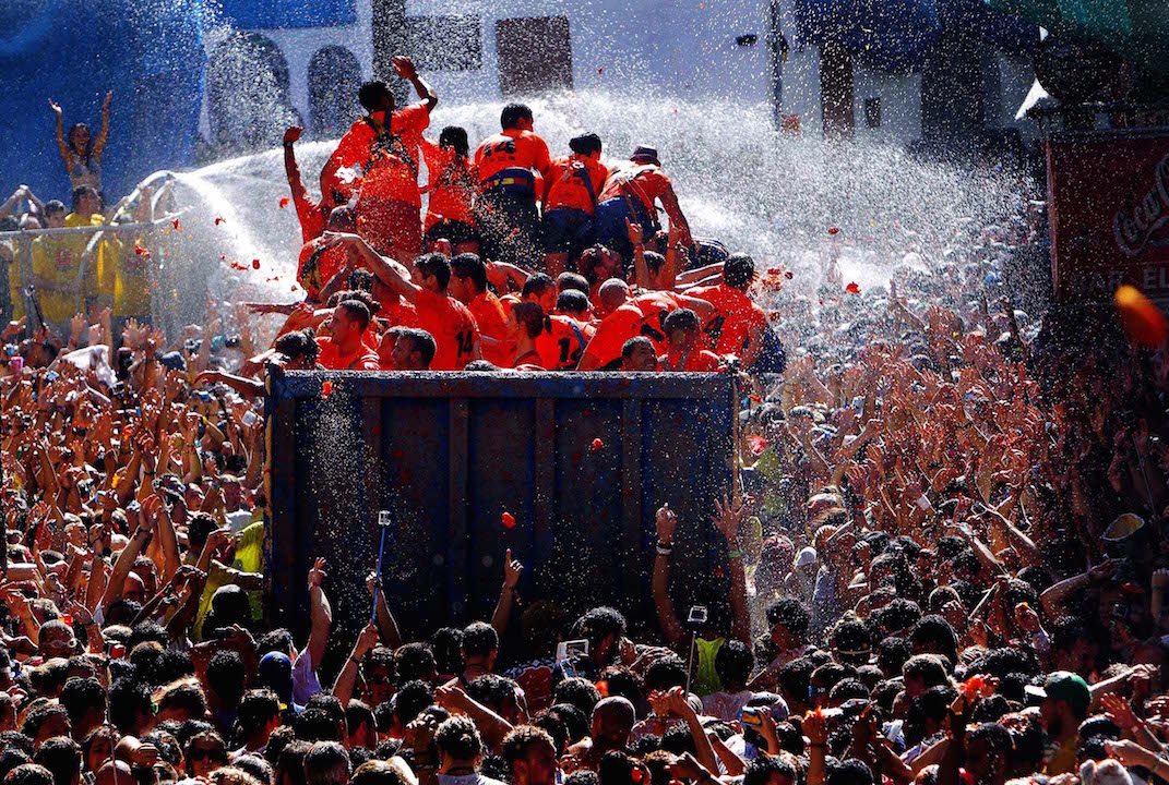 The streets of Bunol, Spain, are awash with red pulp as thousands of people pelt each other with tomatoes in the annual 'Tomatina' tomato fight that has become a major tourist attraction. (Alberto Saiz/Associated Press)