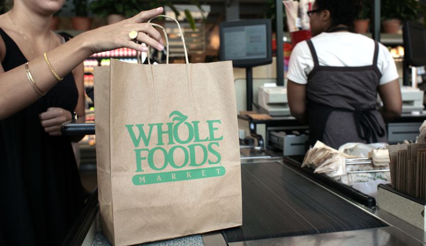 A customer checks out of a Whole Foods Market in Washington,